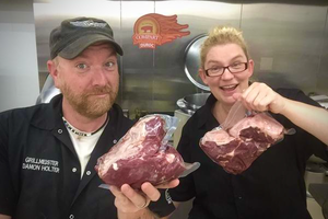 Damon and Lu serve up smoked camel meat at a BBQ Competition